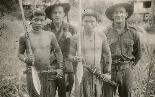 Dyak warriors with unidentified War Correspondents at Limbang, B