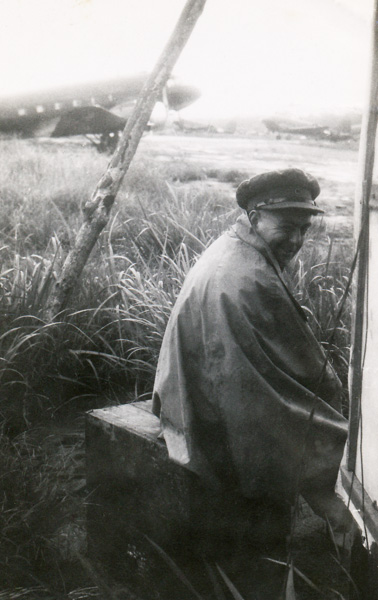 War Correspondnet Jack Hickson taking shelter from the rain at H