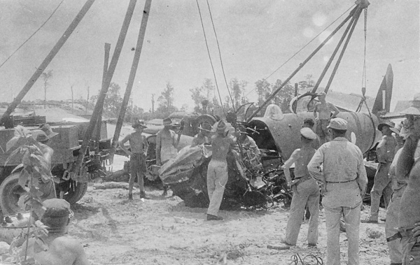 Salvage crew at Morotai airfield retrieving a wrecked Beaufighte